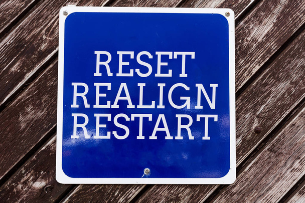 Handwriting text writing Reset Realign Restart. Concept meaning Life audit will help you put things in perspectives Empty blue board with copy space above wooden background. - Photo, Image