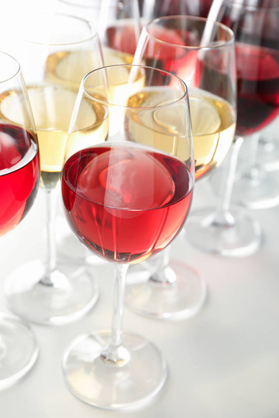 Окуляри з різним вином на білому тлі, крупним планом
 - Фото, зображення
