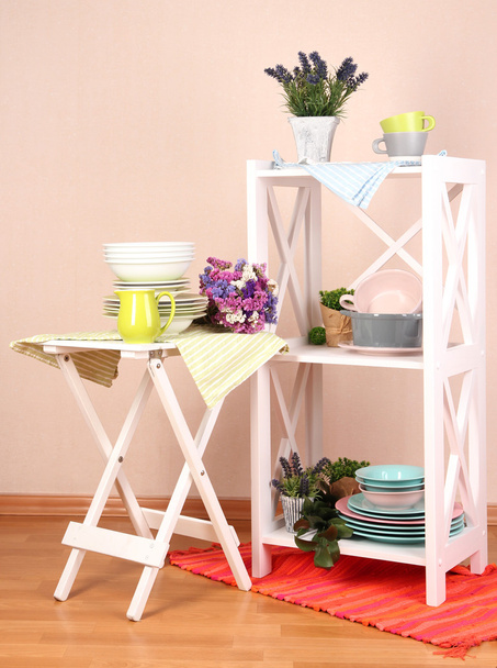 Beautiful white furniture with tableware and decor, on color wall background - Valokuva, kuva