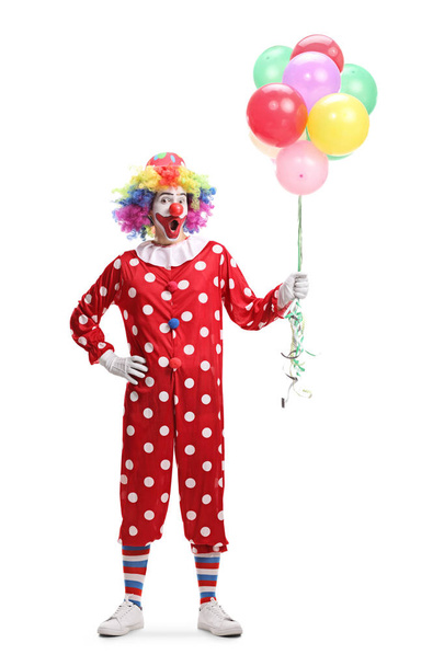 Cheerful clown holding a bunch of balloons - Foto, Bild