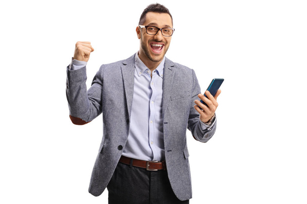 Happy man holding a mobile phone and gesturing yeah  - Photo, image