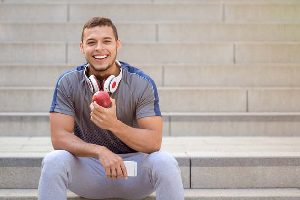 Healthy eating apple fruit runner smiling young man copyspace co - 写真・画像