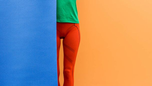 Creative fashion fitness image of sporty girl with yoga mat - Fotó, kép