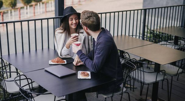 Stylish multiracial couple on date in cafe - Fotoğraf, Görsel