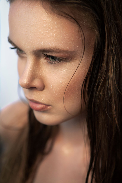 Woman with wet hair looking away - Photo, image