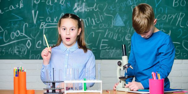 Children studying together classroom. School education. Chemical analysis. Kids study chemistry. School chemistry lesson. School laboratory. Girl and boy communicate while conduct school experiment - Fotó, kép