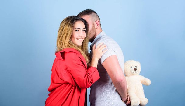 Surprise for sweetheart. Soft toy teddy bear gift. Surprise gift concept. Surprising her. Handsome man and pretty girl in love. Man and woman couple in love. Romantic surprise. Valentines day holiday - Foto, Imagen