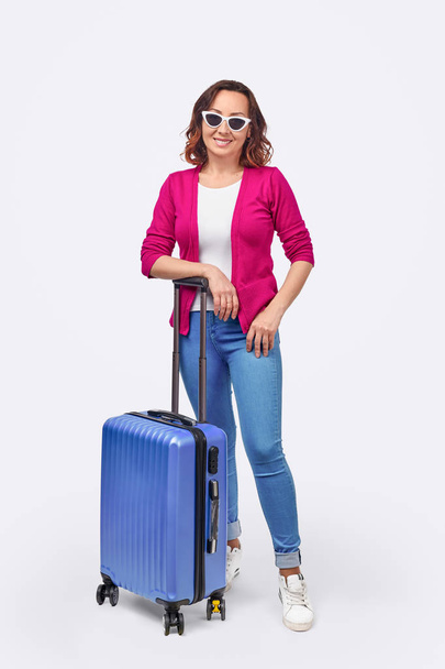 Confident female tourist with luggage - Foto, afbeelding