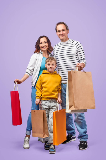 Happy family with shopping bags - Фото, зображення