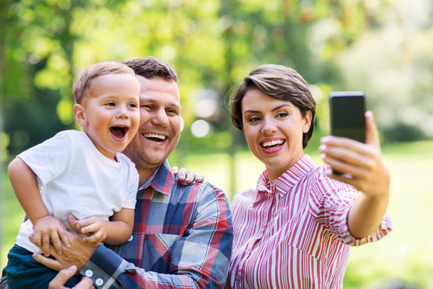 happy family taking selfie at summer park - 写真・画像
