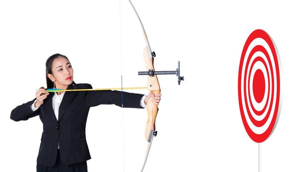 Businesswoman holding bow and shooting to archery target with ta - Photo, Image