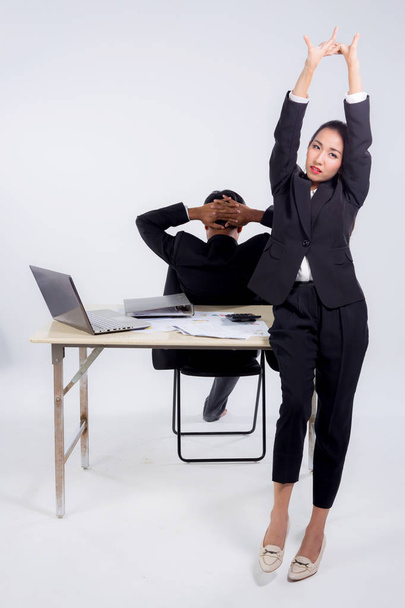 Confident businesswoman and businessman in office with stretch i - Zdjęcie, obraz