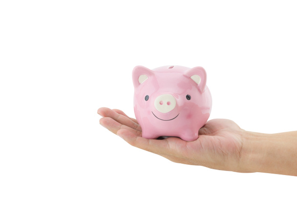 Business man holding a piggy bank isolated on white background. - Photo, image