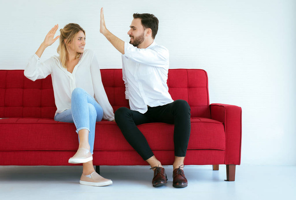 Couple lover hand clapping feeling happy and sitting on sofa at home,Cheerful and attractive people - Fotoğraf, Görsel