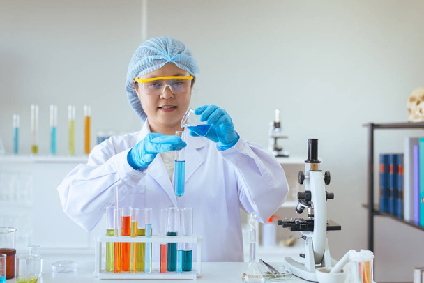 Scientist women working putting medical chemicals sample in test tube at lab - Fotó, kép