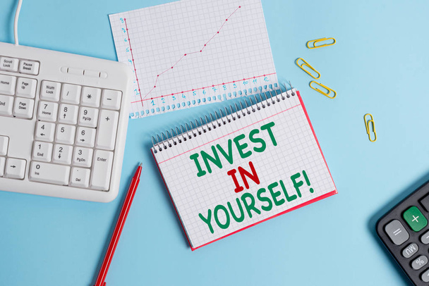 Conceptual hand writing showing Invest In Yourself. Business photo text learn new things or materials thus making your lot better Paper blue keyboard office study notebook chart numbers memo. - Photo, Image