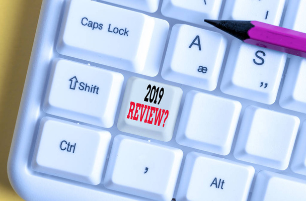 Text sign showing 2019 Review Question. Conceptual photo remembering past year events main actions or good shows White pc keyboard with empty note paper above white background key copy space. - Photo, Image