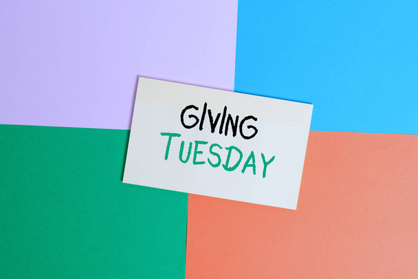 Text sign showing Giving Tuesday. Conceptual photo international day of charitable giving Hashtag activism Office appliance colorful square desk study supplies empty paper sticker. - Fotó, kép