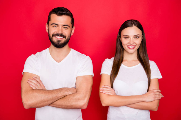 Photo of two charming casual beautiful cute handsome pretty sweet trendy nice people together coworking while wearing white t-shirts isolated over red background - Фото, изображение