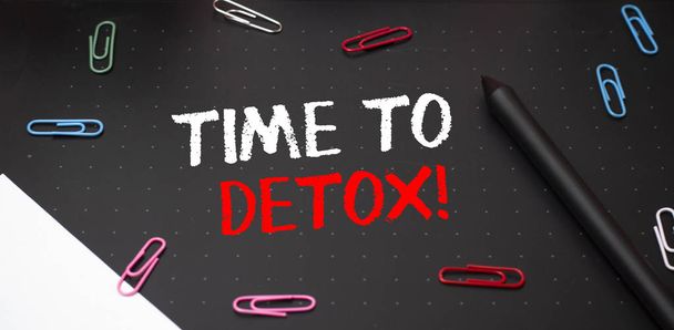 Writing note showing Time To Detox. Business photo showcasing when you purify your body of toxins or stop consuming drug Scissors and writing equipments plus math book above textured backdrop. - Photo, Image