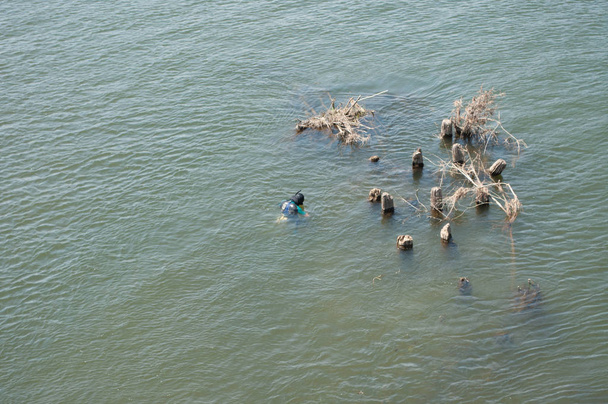 scuba diver swims in the green river - Fotó, kép
