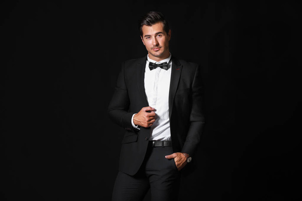 Fashionable man in formal clothes on dark background - Photo, Image