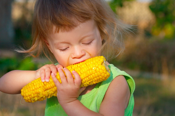 child to eat boiled corncob - Photo, Image