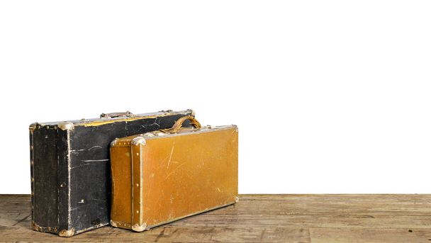 Old suitcases on wooden floor isolated on white - Photo, Image