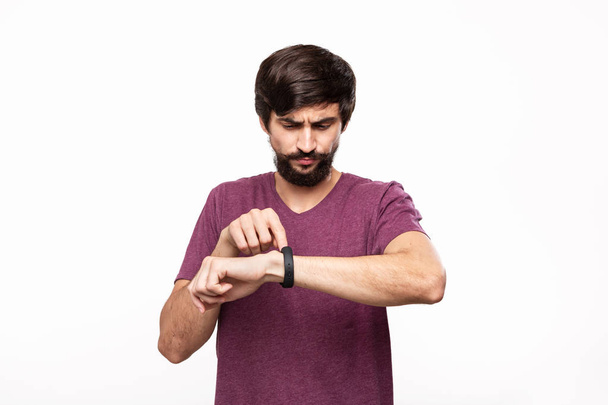 Nadšený vousatý muž s knírkami, který se dívá s inteligentními hodinky. Používání moderních technologií v každodenním životě. - Fotografie, Obrázek