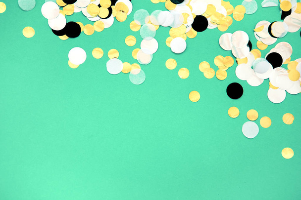 foil confetti sparse on trendy mint colored background - Foto, afbeelding