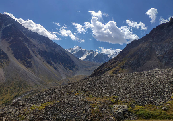 Транс-Гілі Алатау, гірський хребет Тянь-Шань в Казахстані поблизу міста Алмати. Скелясті вершини вкриті снігом і льодовиками в середині літа під хмарами - Фото, зображення