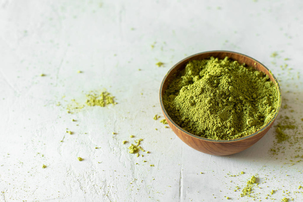 Matcha tea in a brown cup on a gray background - Photo, image