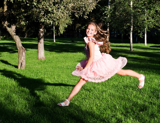 Adorable happy little girl child is running and having fun in th - Фото, зображення