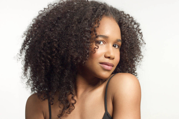 closeup portrait s of young mixed race model with curly hair in studio with natural neutral makeup - Foto, Imagen