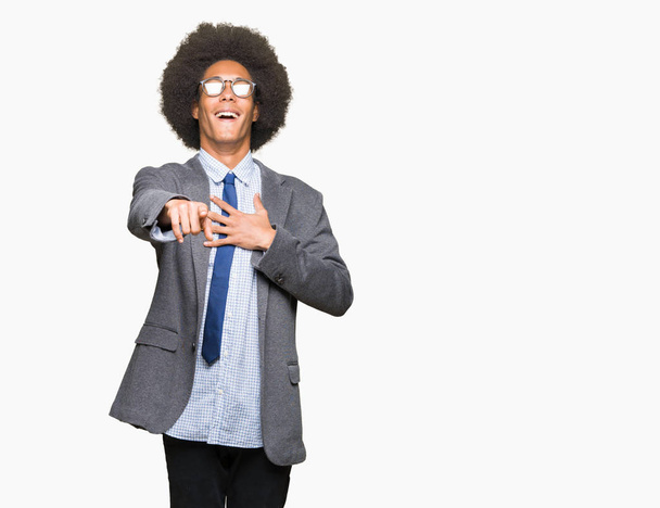 Young african american business man with afro hair wearing glasses Laughing of you, pointing to the camera with finger hand over chest, shame expression - Photo, Image