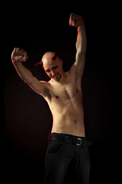 Man posing in styling of devil - Foto, afbeelding