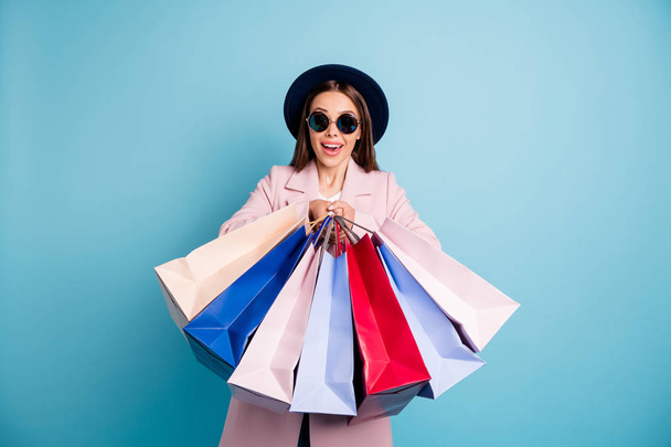 Portrait of astonished surprised lady in eyewear eyeglasses go shopping have incredible discount scream wow omg wear pink coat isolated over blue color background - Фото, зображення