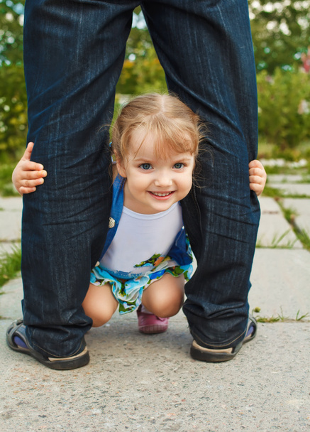 little girl holding the feet of parents - Фото, изображение