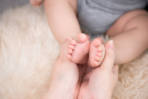 赤ちゃんと母親の足のクローズアップ - 写真・画像