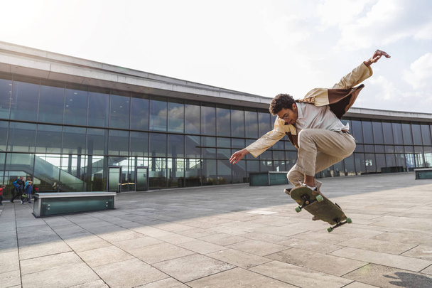 Afro man skateboarder flies in air on skateboard - Photo, image