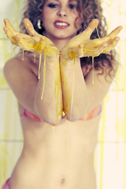 Young woman playing with melted Jelly - Фото, изображение