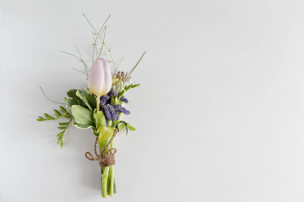 Mini bouquet of blue flowers, tulips and freesias on a white background. - Foto, immagini