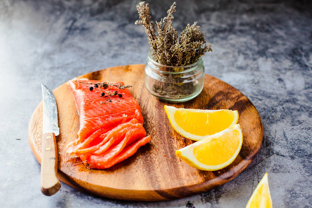 Salted smoked salmon with rosemary on a wooden board. Healthy fo - Fotografie, Obrázek