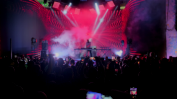 blurry deejay plays on concert stage crowd films - Footage, Video