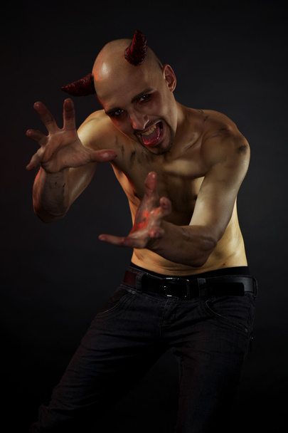 Man posing in styling of devil - Valokuva, kuva