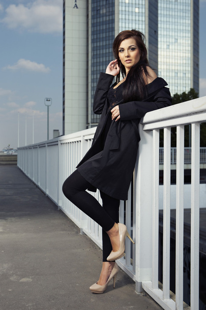 Beautiful young brunette lady posing on city - Valokuva, kuva
