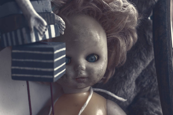 Creepy sinister old broken dirty abandoned doll as halloween concept - Φωτογραφία, εικόνα