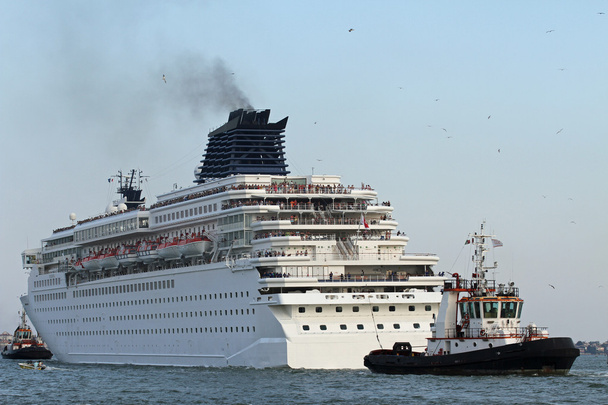 cruise ship leaves the port city with the help of powerful naval - Photo, Image