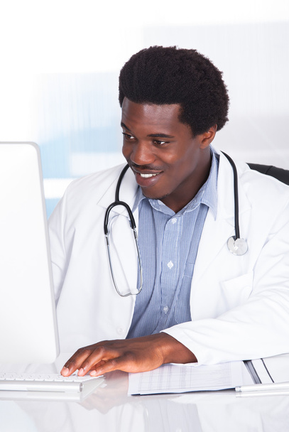 Happy Doctor With Stethoscope Sitting At A Desk - Zdjęcie, obraz