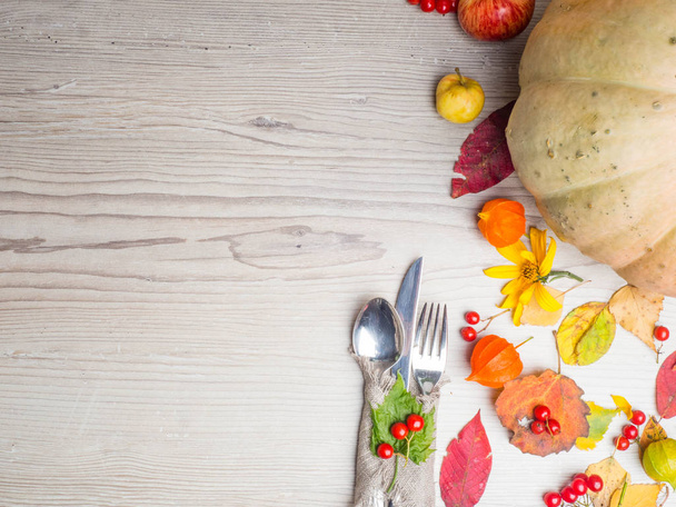 Thanksgiving autumn fall table setting copy space background, with pumpkin, leaf, red berries - Photo, Image